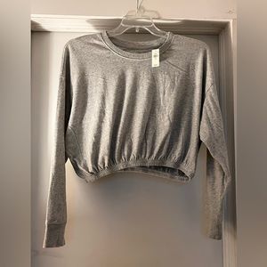 Cropped, grey lounge/workout top.